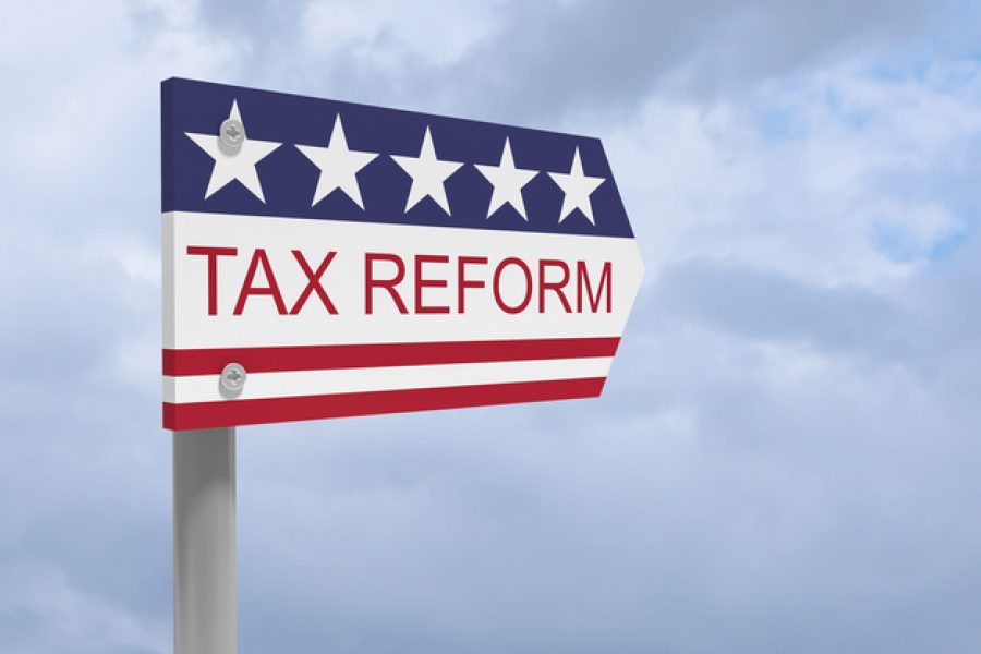 USA Politics Concept: Tax Reform Direction Sign With US Flag, 3d illustration against cloudy sky